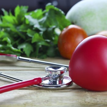 Healthy hearth concept, vegetable and fruit with herb leaf and ear doctor on wood background