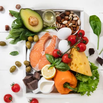 Ketogenic low carbs diet - food selection on white wooden background. Balanced healthy organic ingredients of high content of fats. Nutrition for the heart and blood vessels. Meat, fish and vegetables.